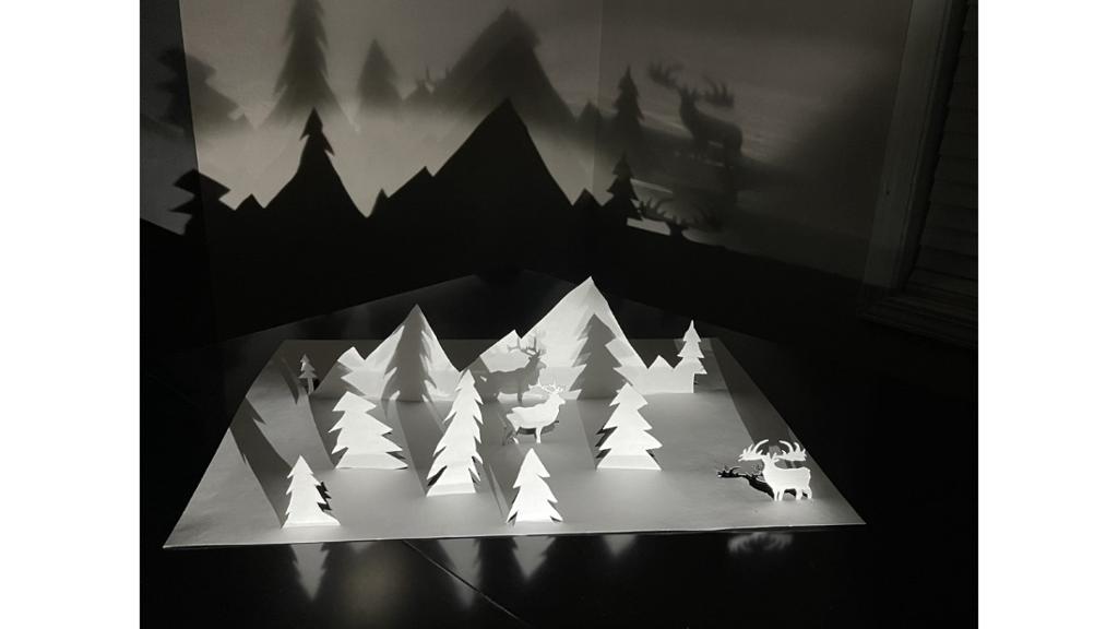 Paper cut out of trees, mountain, deer
