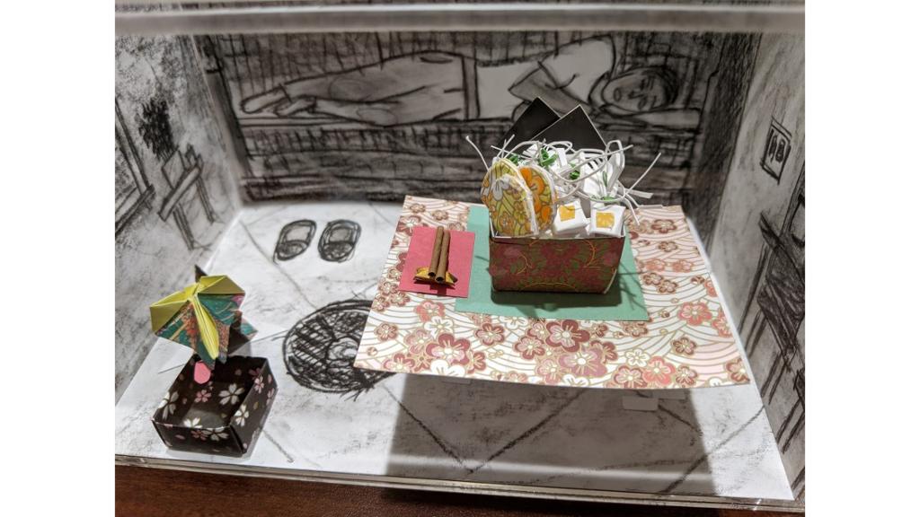3d table with various paper groceries and drawing of person on background