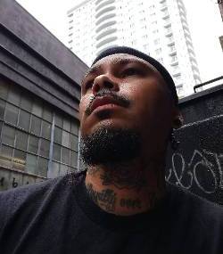 Headshot of Carlos Khali in front of a cityscape