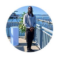 male standing near waterfront