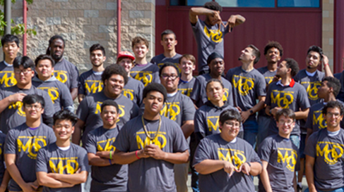 A cohort of Men of Distinction students pose wearing matching t-shirts