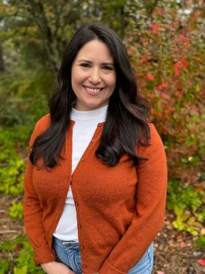 Image of a Latinx woman in an orange sweater