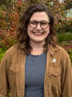 Image of white woman in tan jacket