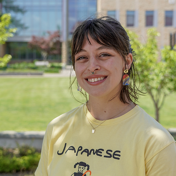 grad wearing t-shirt and smiling