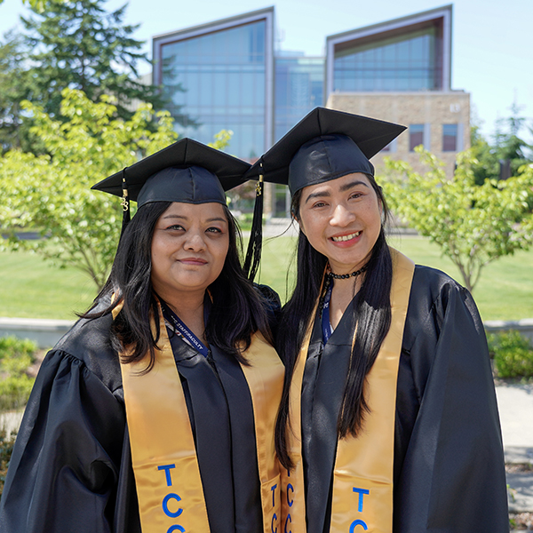 two grads in regalia