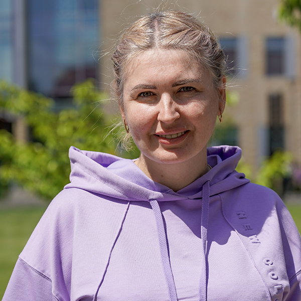 grad wearing purple sweatshirt