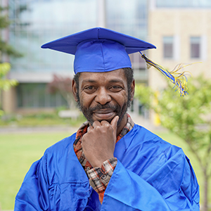 A graduate in blue regalia