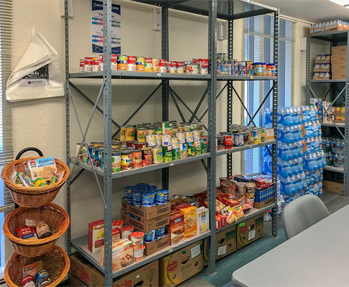 A tall rack is filled with cans and boxes of non-perishable food items