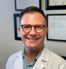 Profile picture of smiling man in glasses