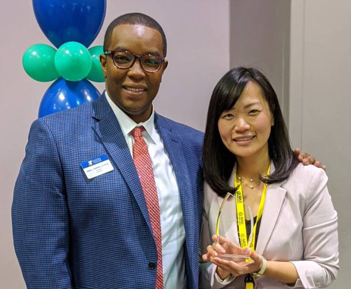 Photo of Ivan Harrell and Namiko Bagirimvano with award