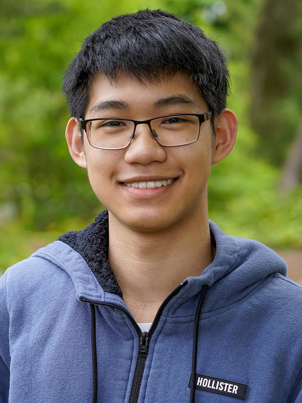 picture of a man with glasses in a blue sweatshirt smiling